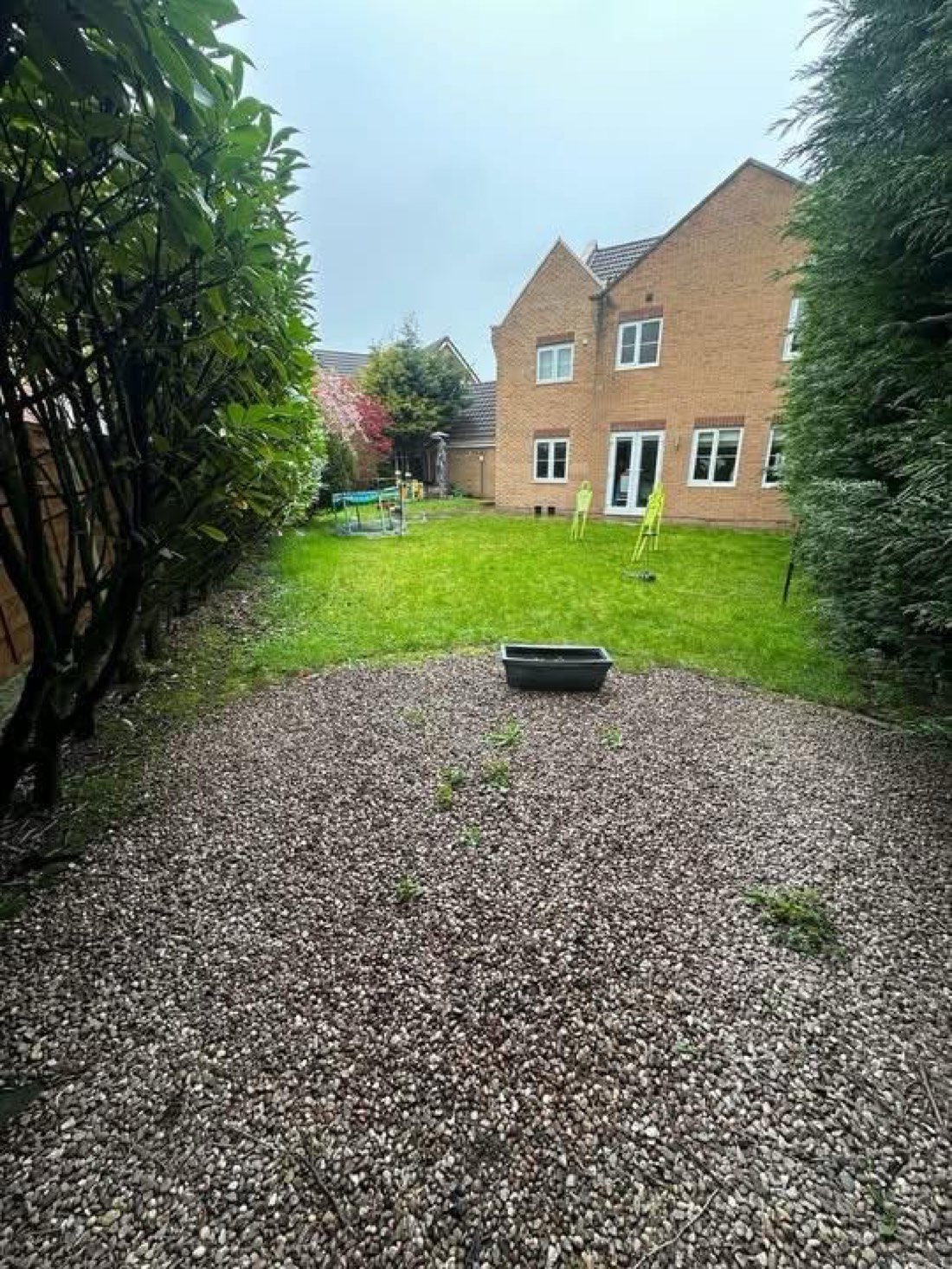 Dominic's back garden before the rebuild — tired lawn and worn gravel area