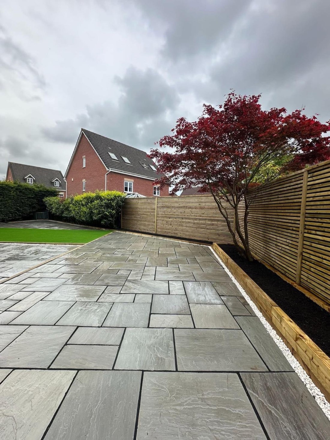 New Venetian slatted fencing and sleeper raised beds with an acer in Dominic's garden