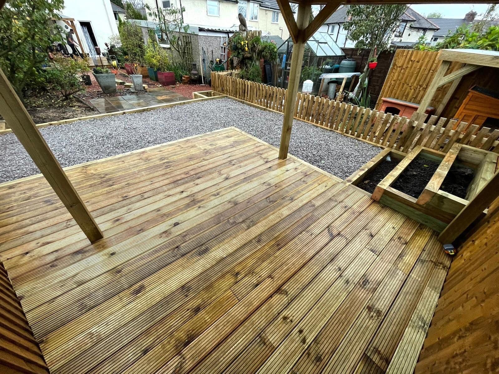 Timber decking seating area installed in a Bolton garden by Northwest Elite Scaping
