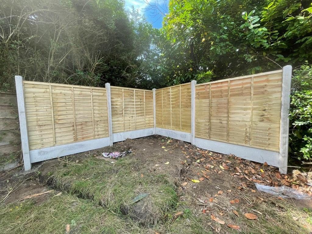 Fence panels with trellis topper installed in a Bolton garden