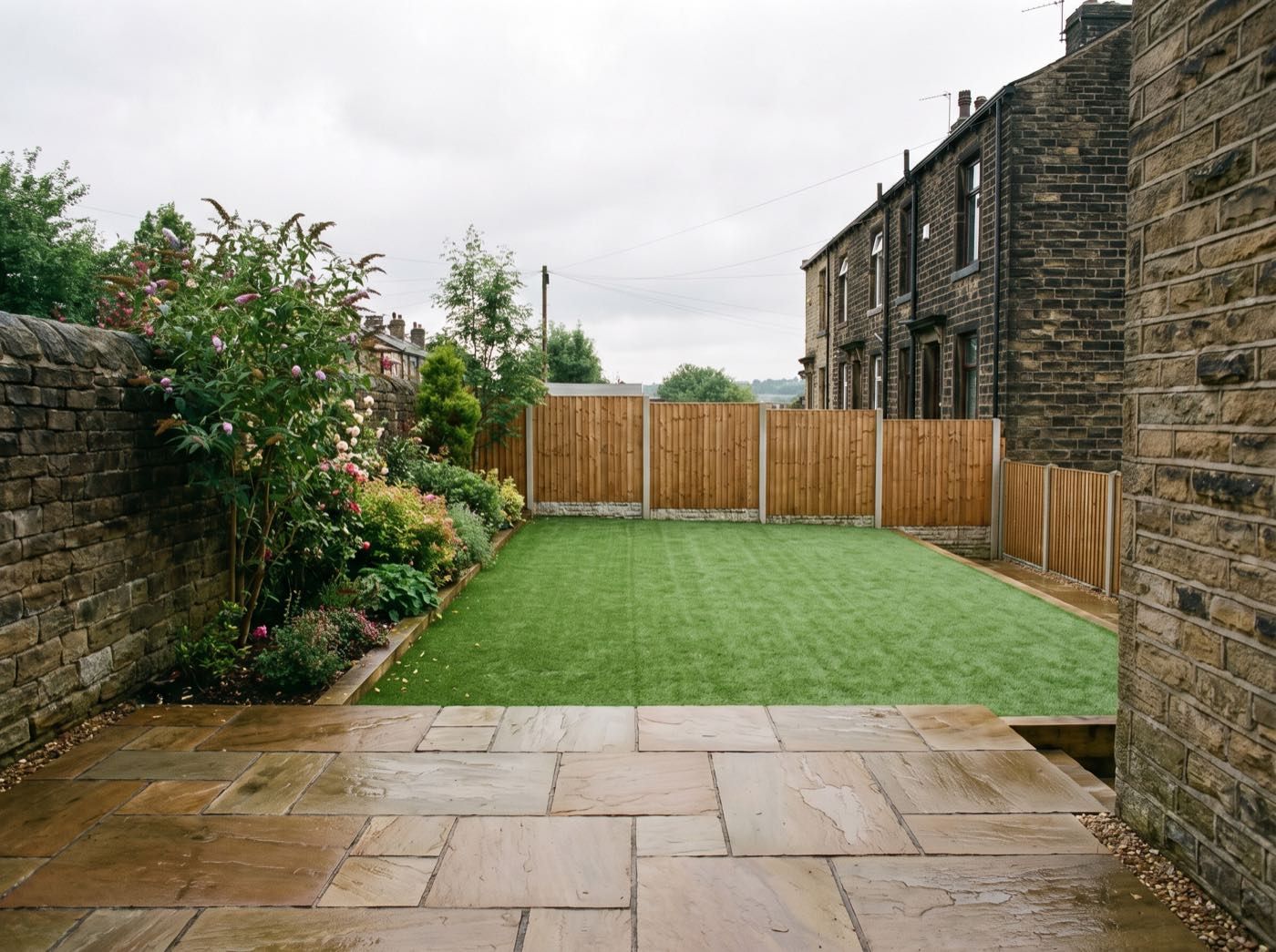 Finished back garden in Oldham after landscaping, with a new patio, lawn and fence (illustrative)
