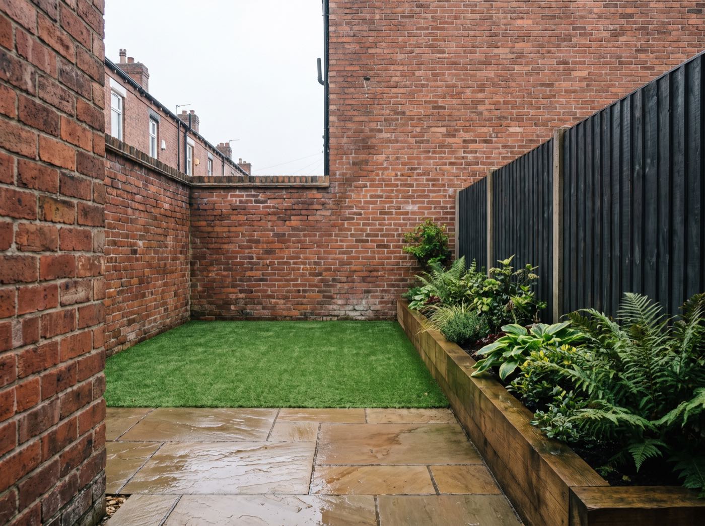 Finished back garden in Salford after landscaping, with a new patio, lawn and fence (illustrative)