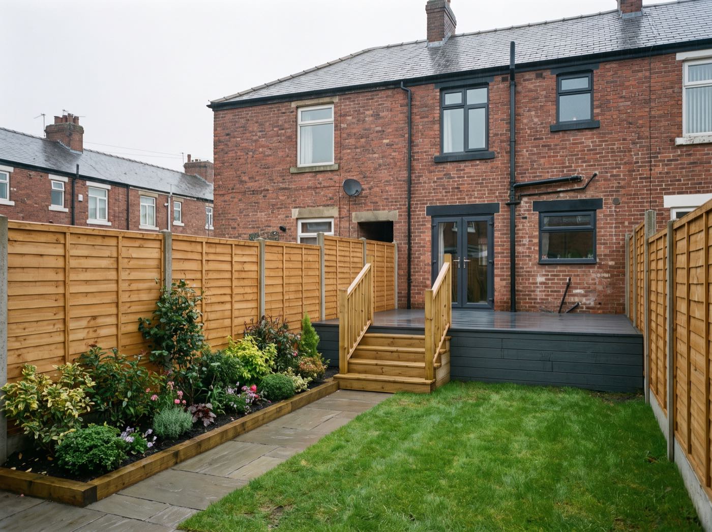 Finished back garden in Salford after landscaping, with a new patio, lawn and fence (illustrative)