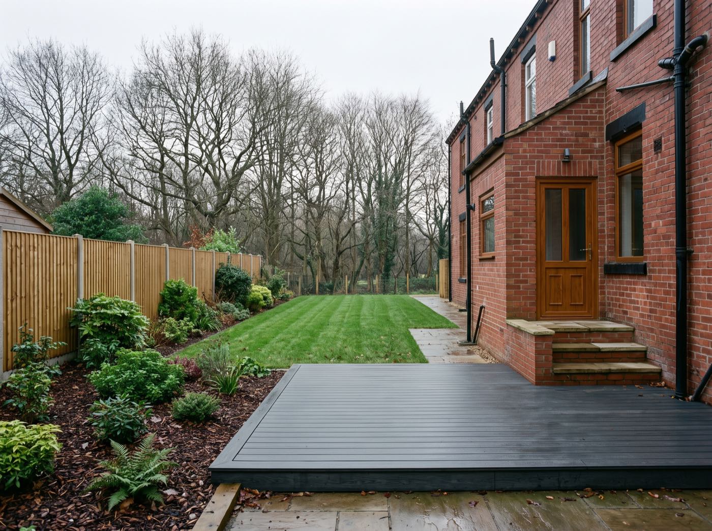 Finished back garden in Wigan after landscaping, with a new patio, lawn and fence (illustrative)
