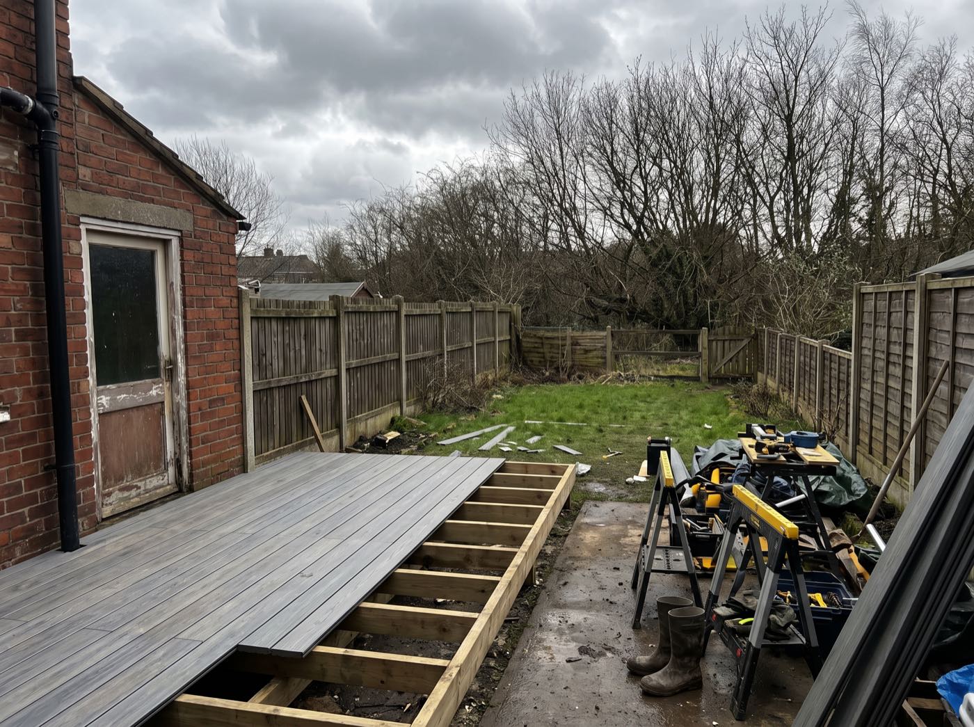 Decking boards being laid in a Wigan back garden (illustrative)