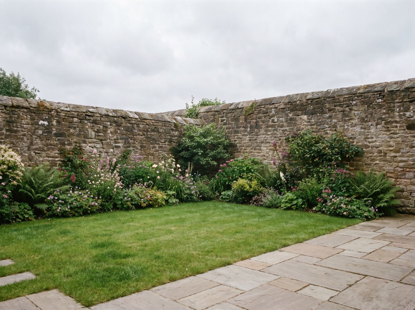 Finished back garden in Adlington after landscaping, with a new patio, lawn and fence (illustrative)