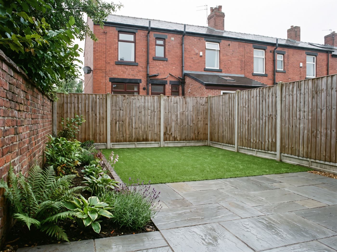 Finished back garden in Aspull after landscaping, with a new patio, lawn and fence (illustrative)