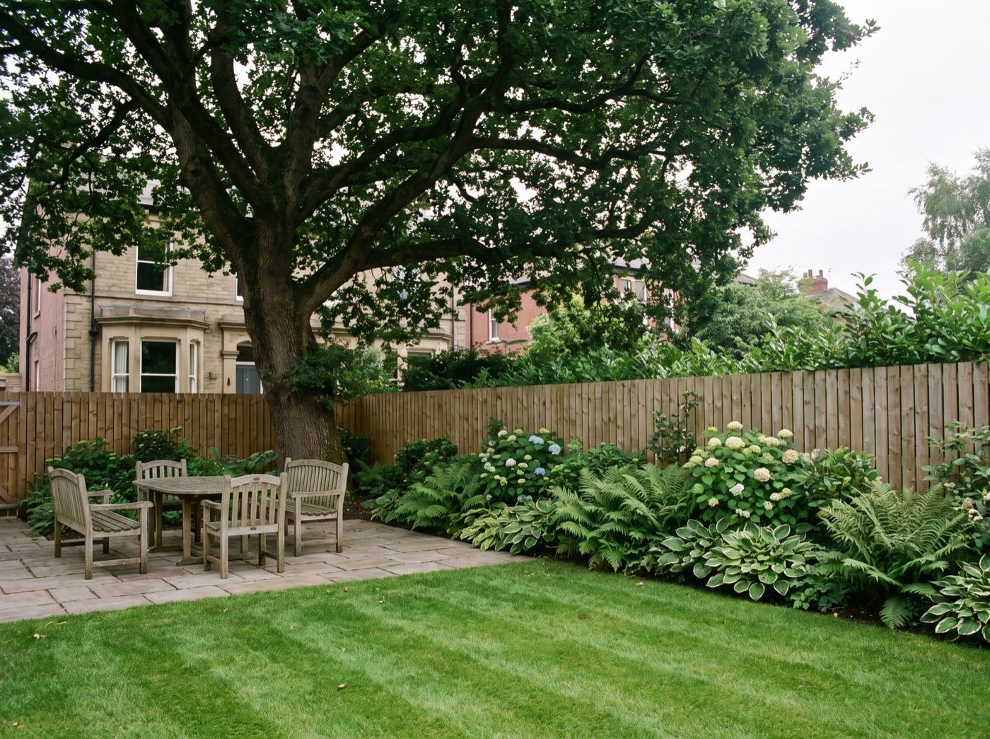 Finished back garden in Bromley Cross after landscaping, with a new patio, lawn and fence (illustrative)