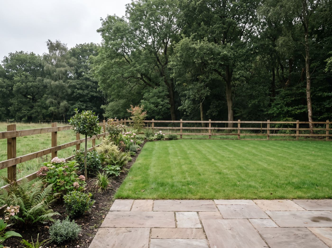 Finished back garden in Haigh after landscaping, with a new patio, lawn and fence (illustrative)