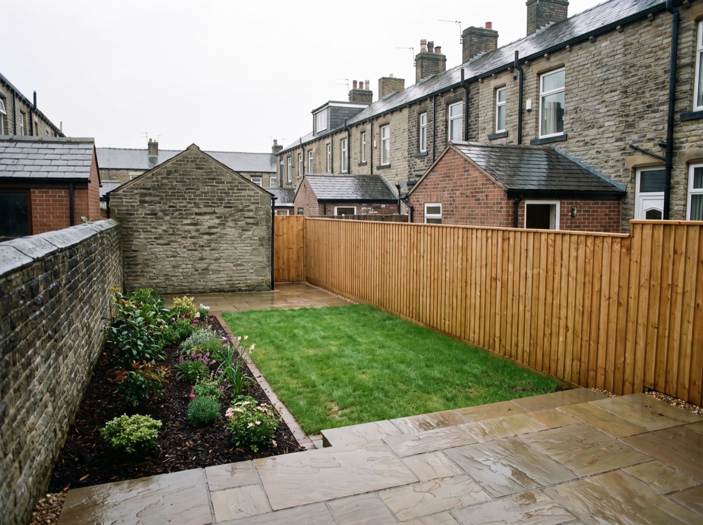 Finished back garden in Halliwell after landscaping, with a new patio, lawn and fence (illustrative)