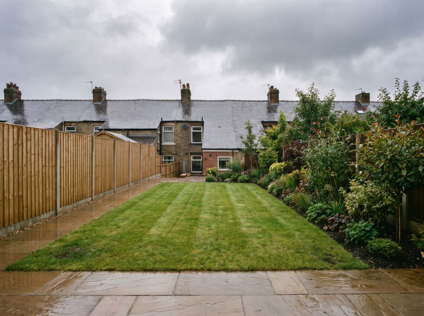 Finished back garden in Kearsley after landscaping, with a new patio, lawn and fence (illustrative)