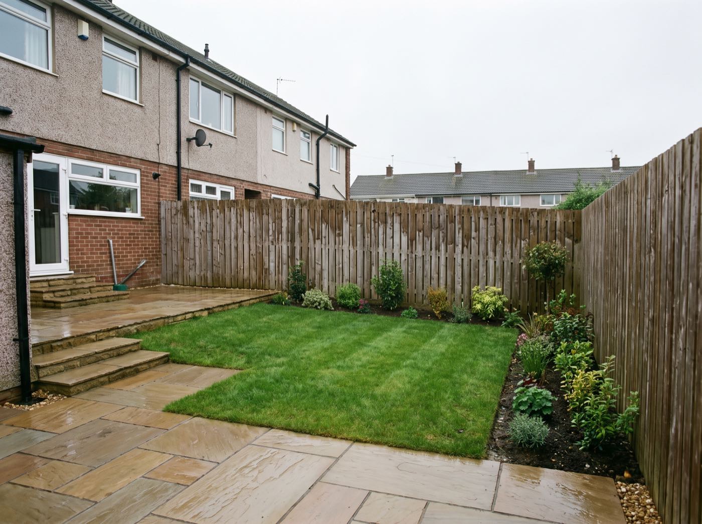 Finished back garden in Little Lever after landscaping, with a new patio, lawn and fence (illustrative)